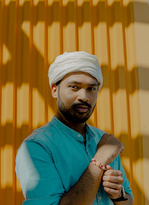 Man Standing Beside Yellow Wall