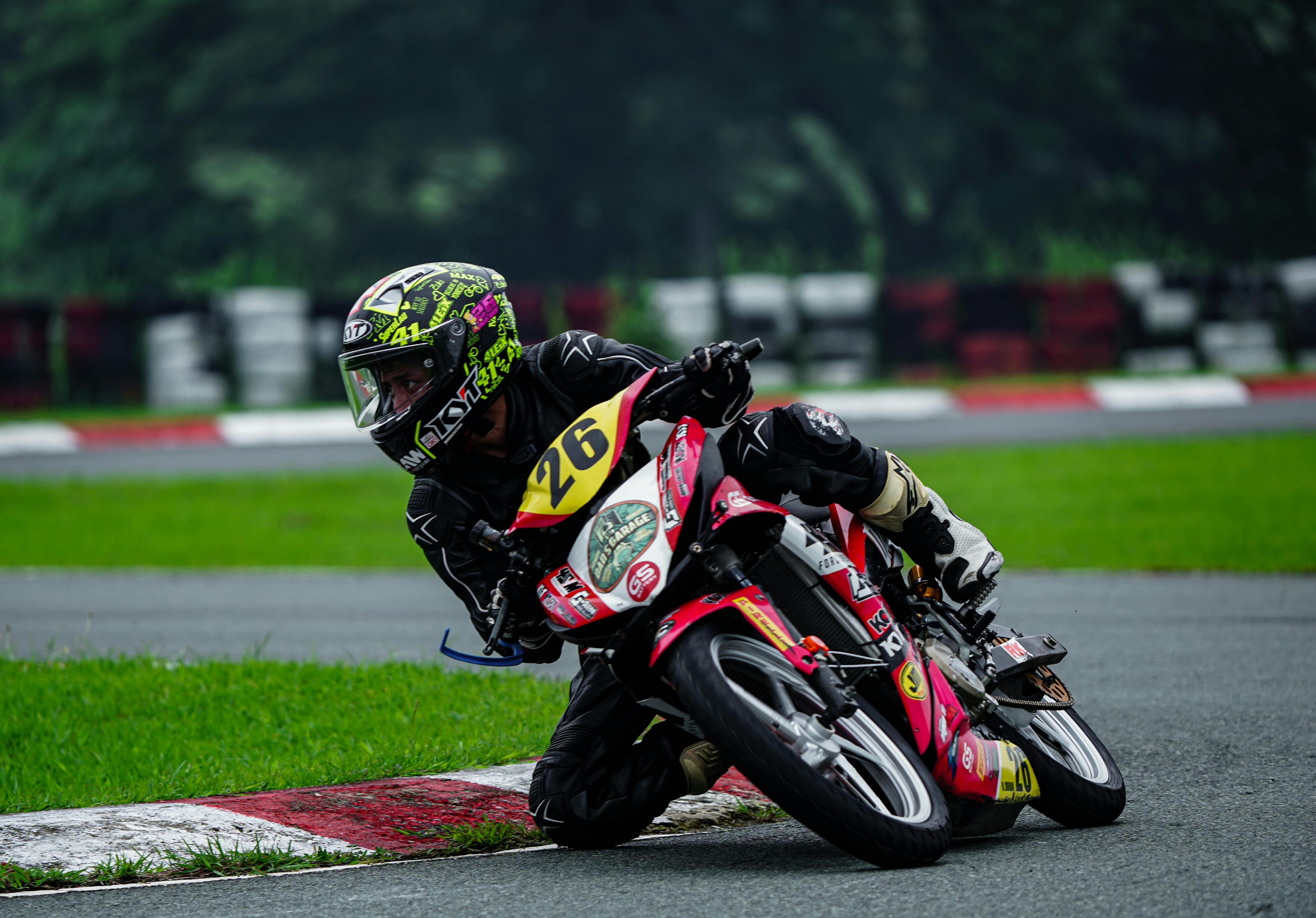 Dynamic capture of a motorcycle race in Tarlac City, showcasing agility and speed on a wet track.
