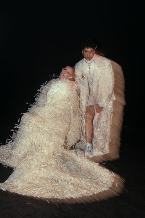 Free Artistic portrait of two models in unique white attire with motion blur effect. Stock Photo