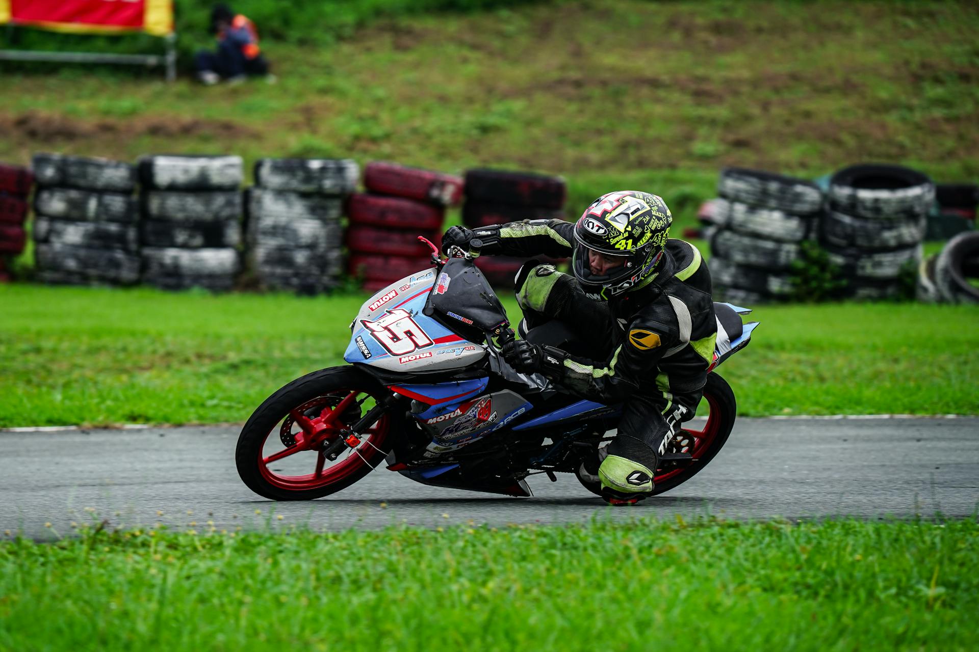 Motorcycle Racer on Track Leaning into Corner