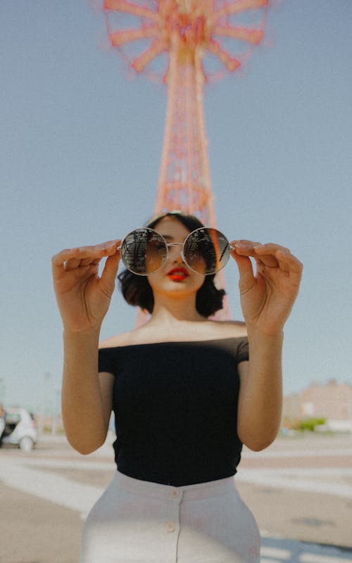 Free Woman Holding Round Sunglasses Stock Photo
