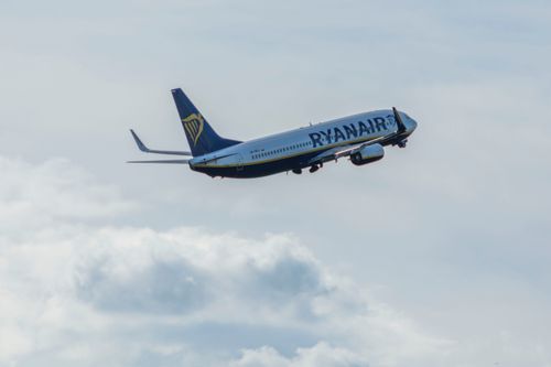 Free A Ryanair plane soaring through the sky above Wrocław, Poland. Stock Photo