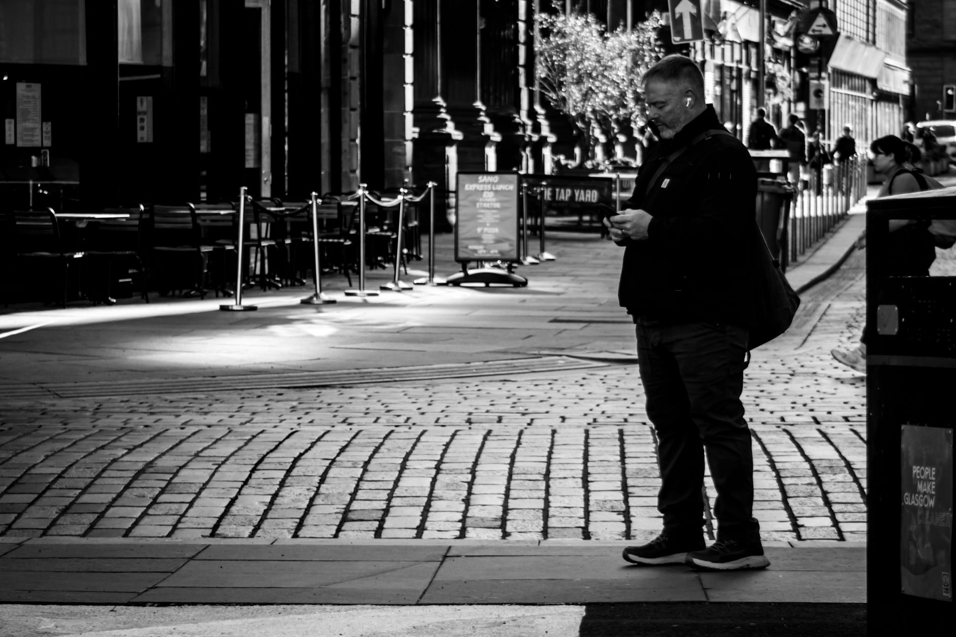 Urban Scene in Glasgow with Man Using Mobile