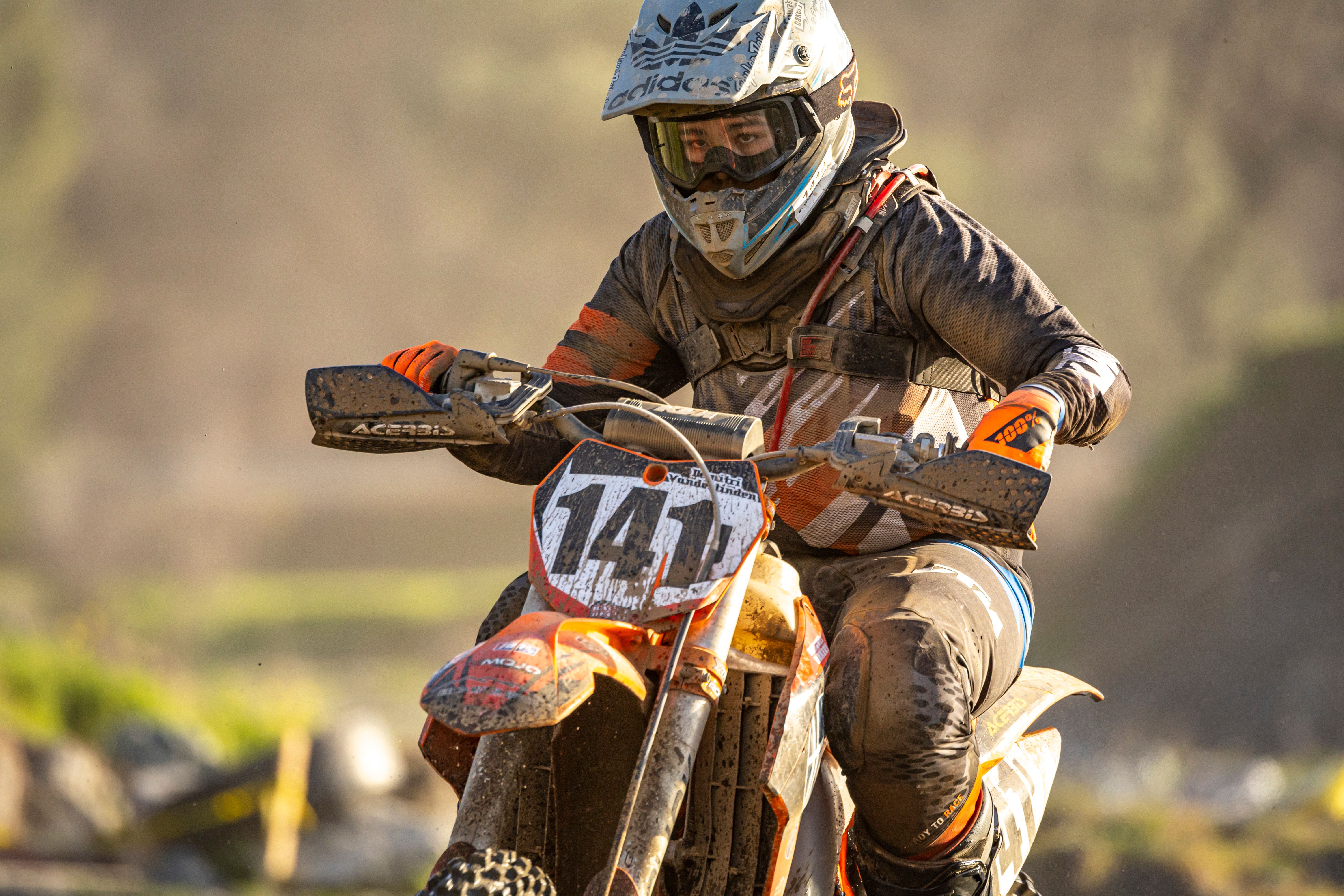 Dirt bike rider competes in a thrilling off-road race, showcasing skill and determination.