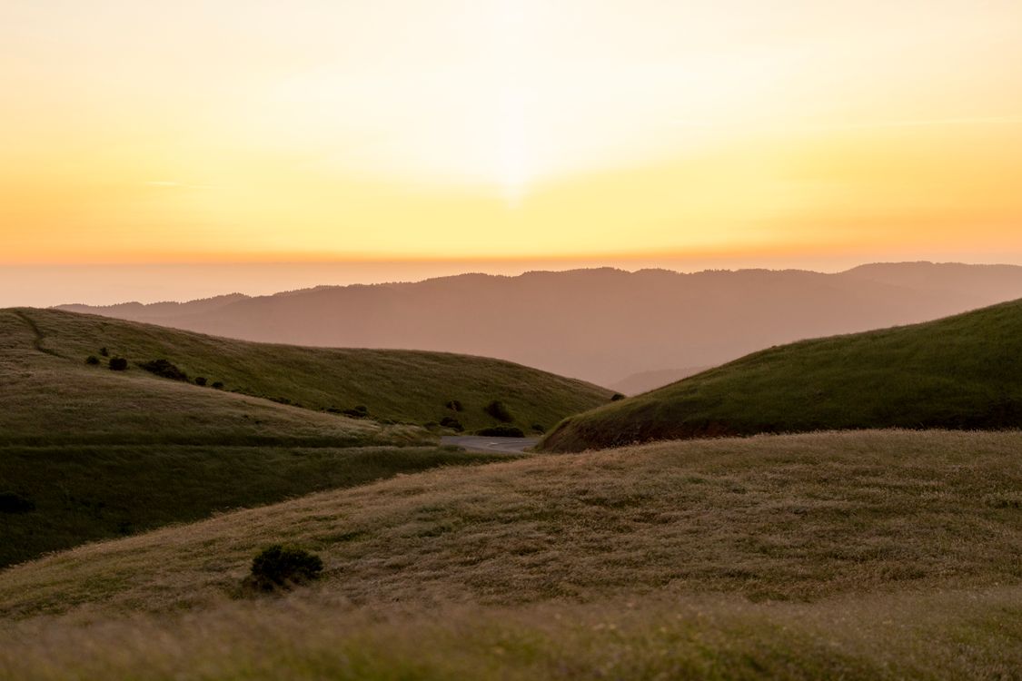 Sunset over Rolling Hills with Golden Sky · Free Stock Photo