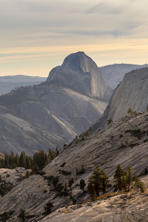 Free Scenic view of Half Dome at Yosemite National Park with mountainous landscape under a cloudy sky. Stock Photo