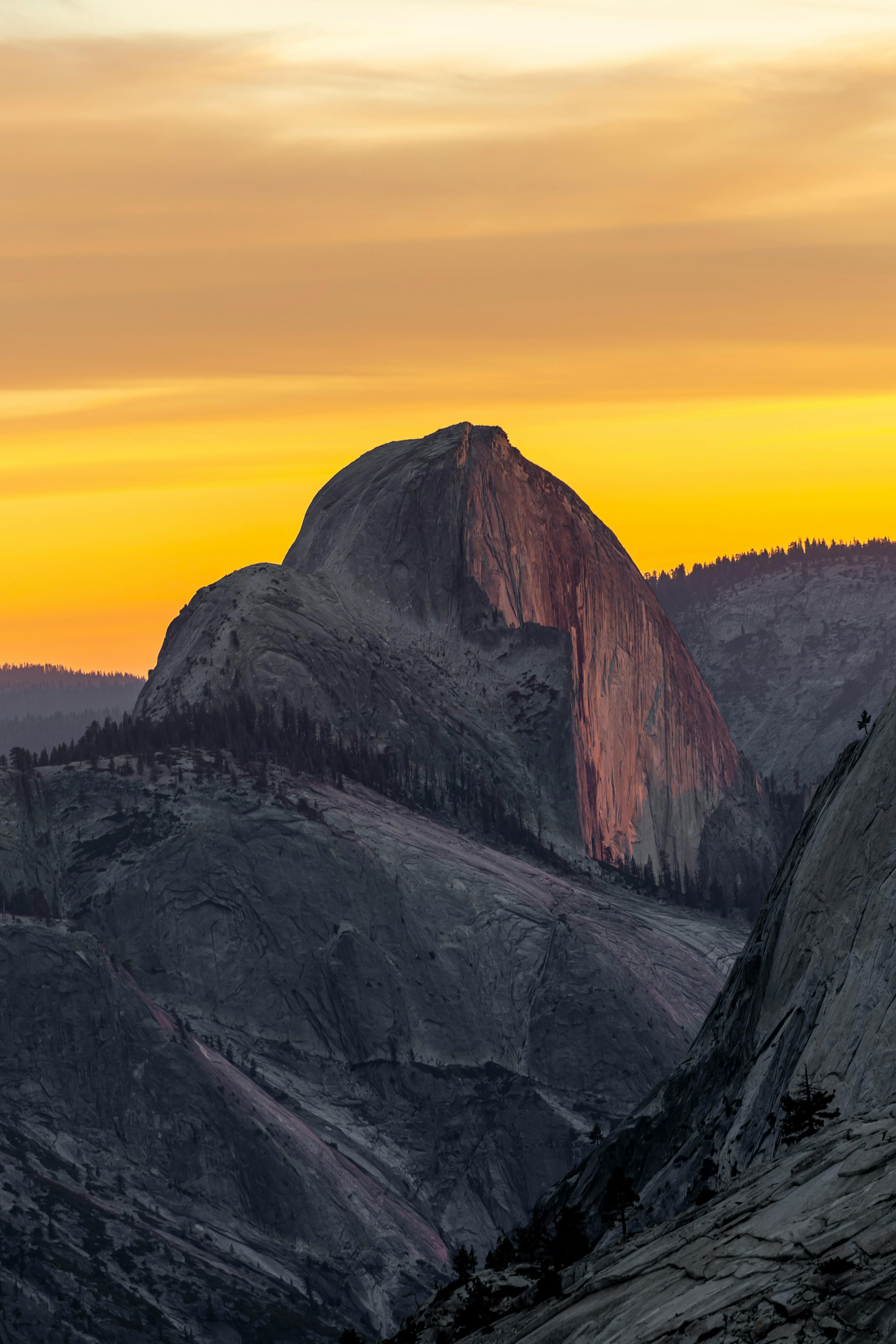 Breathtaking view of Half Dome with vibrant sunset hues in Yosemite National Park.
