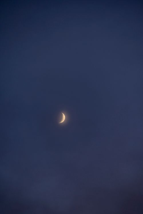 Free Peaceful crescent moon surrounded by dark blue sky, embodying tranquility. Stock Photo