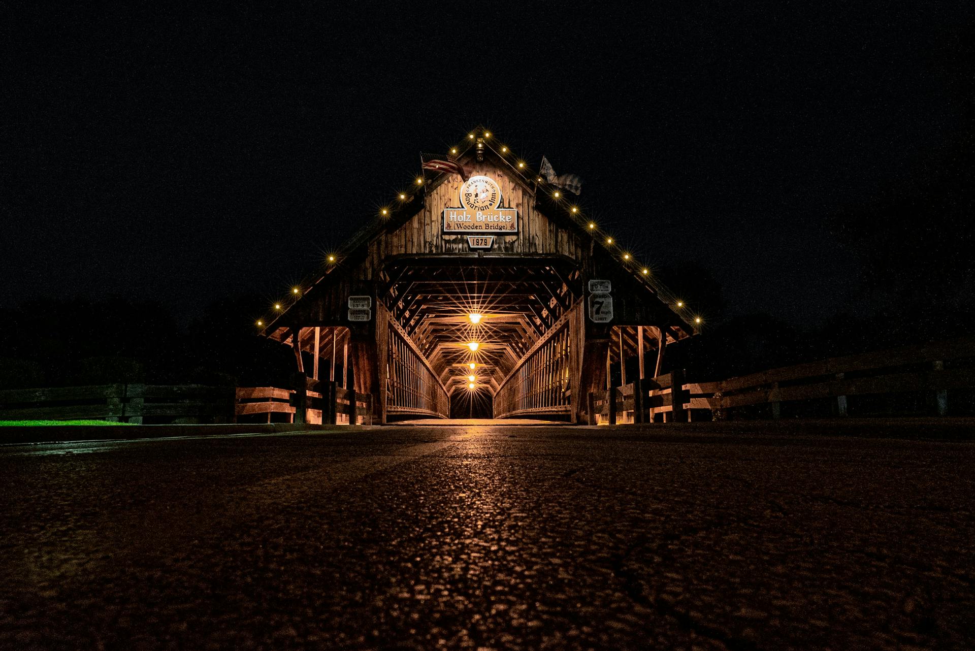 A captivating night shot of the illuminated Holz Brücke Wooden Bridge in Frankenmuth.