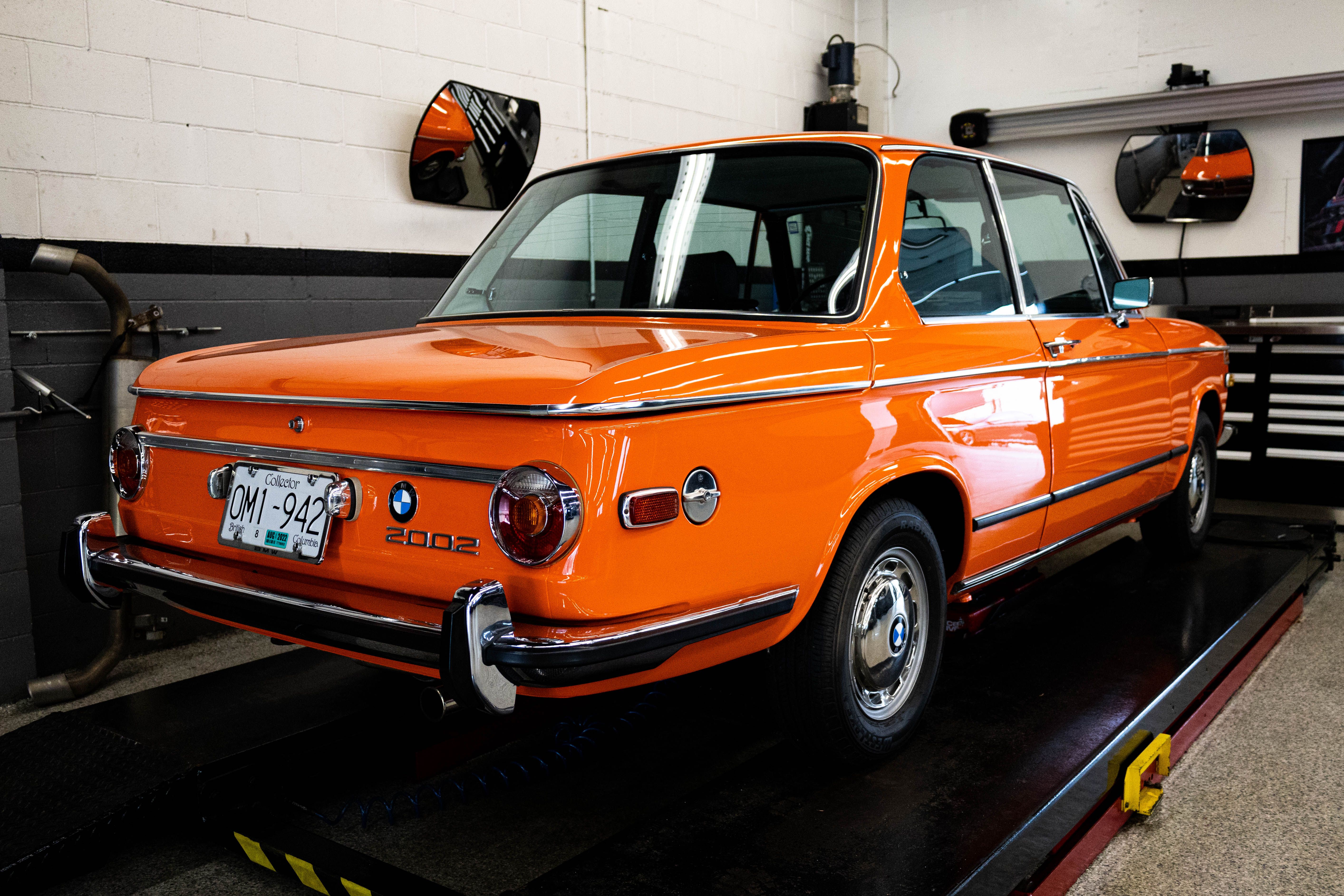 Vintage Orange BMW 2002 in Garage Setting · Free Stock Photo