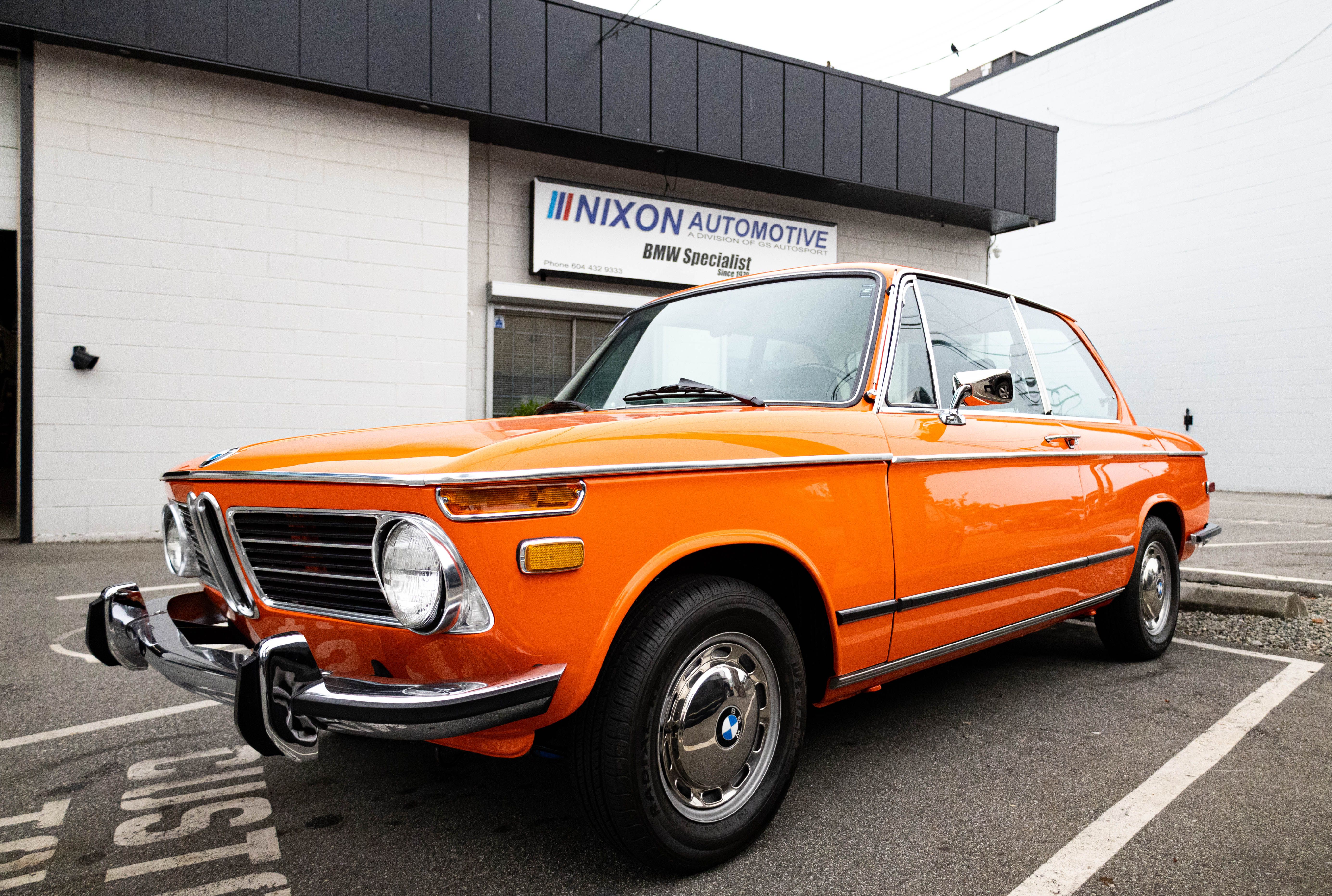Vintage Orange BMW Classic Car in Urban Setting · Free Stock Photo
