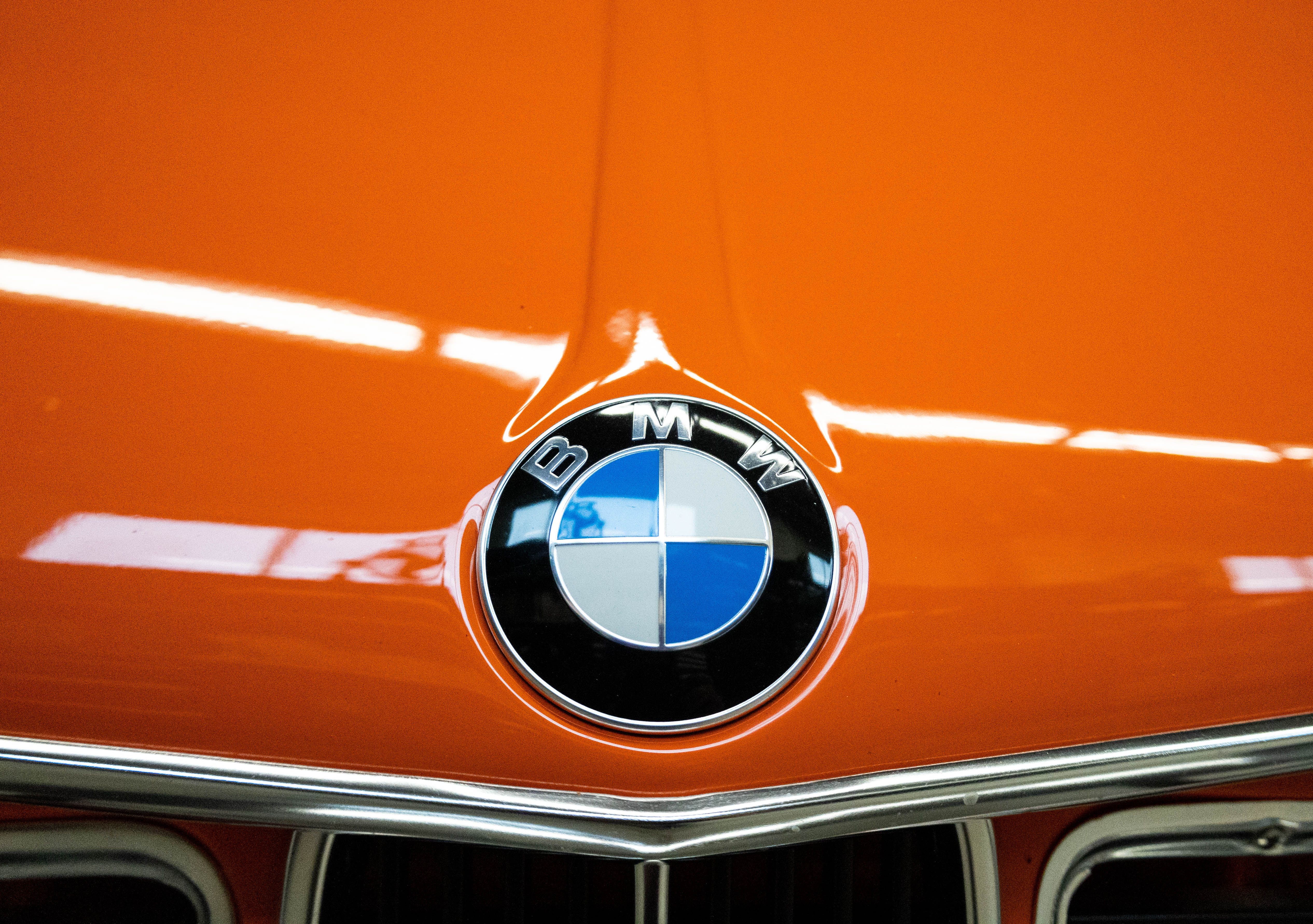 Bright Orange Vintage BMW Hood Emblem Close-Up · Free Stock Photo