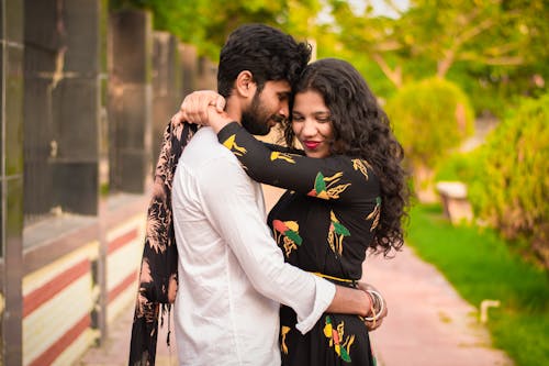 Free Woman and Man Hugging on Streets Stock Photo