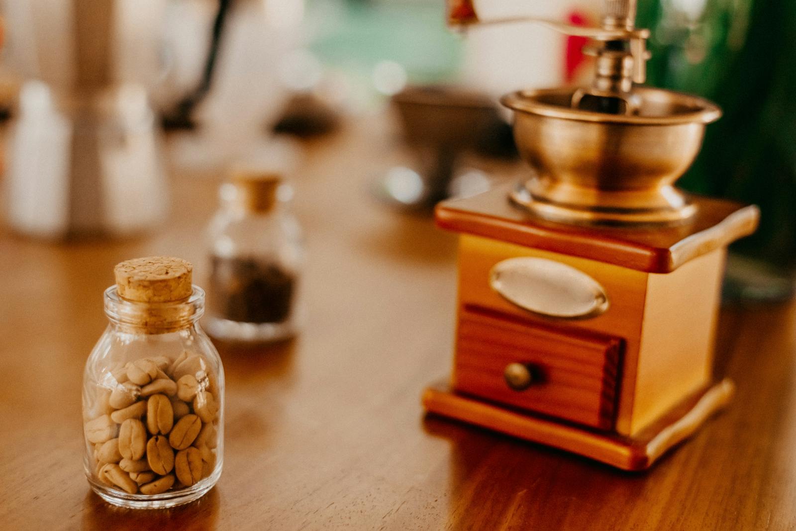 Old coffee beans in a small jar on a wooden table