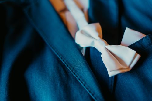 Free Close-up of a stylish blue suit with a crisp white bow tie, perfect for formal occasions. Stock Photo