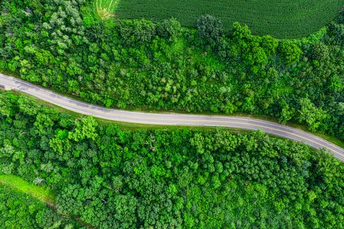 Free Aerial view of a winding road through lush green countryside in Goodhue, Minnesota. Stock Photo