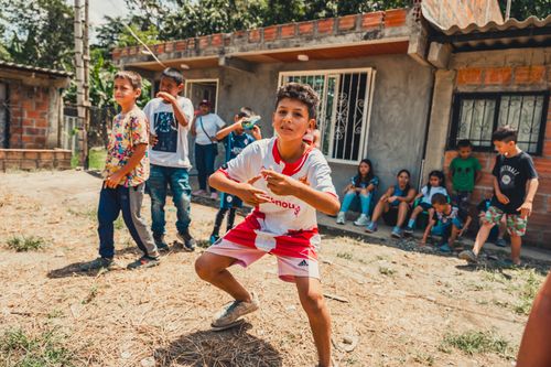 Free Kids enjoying a playful day outdoors in a rustic neighborhood setting, showcasing community spirit. Stock Photo