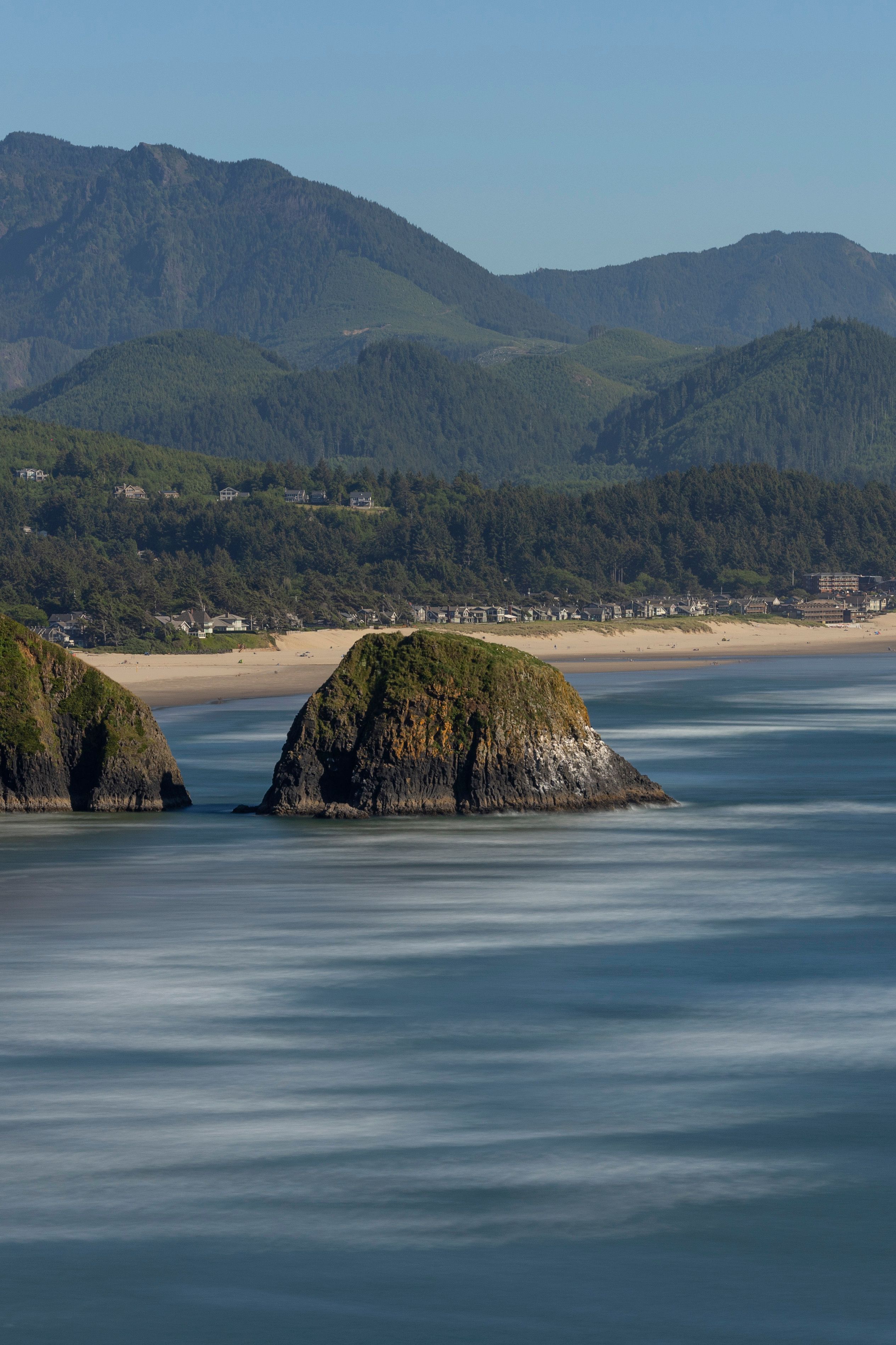 Scenic Oregon coastline with sea stacks and mountains