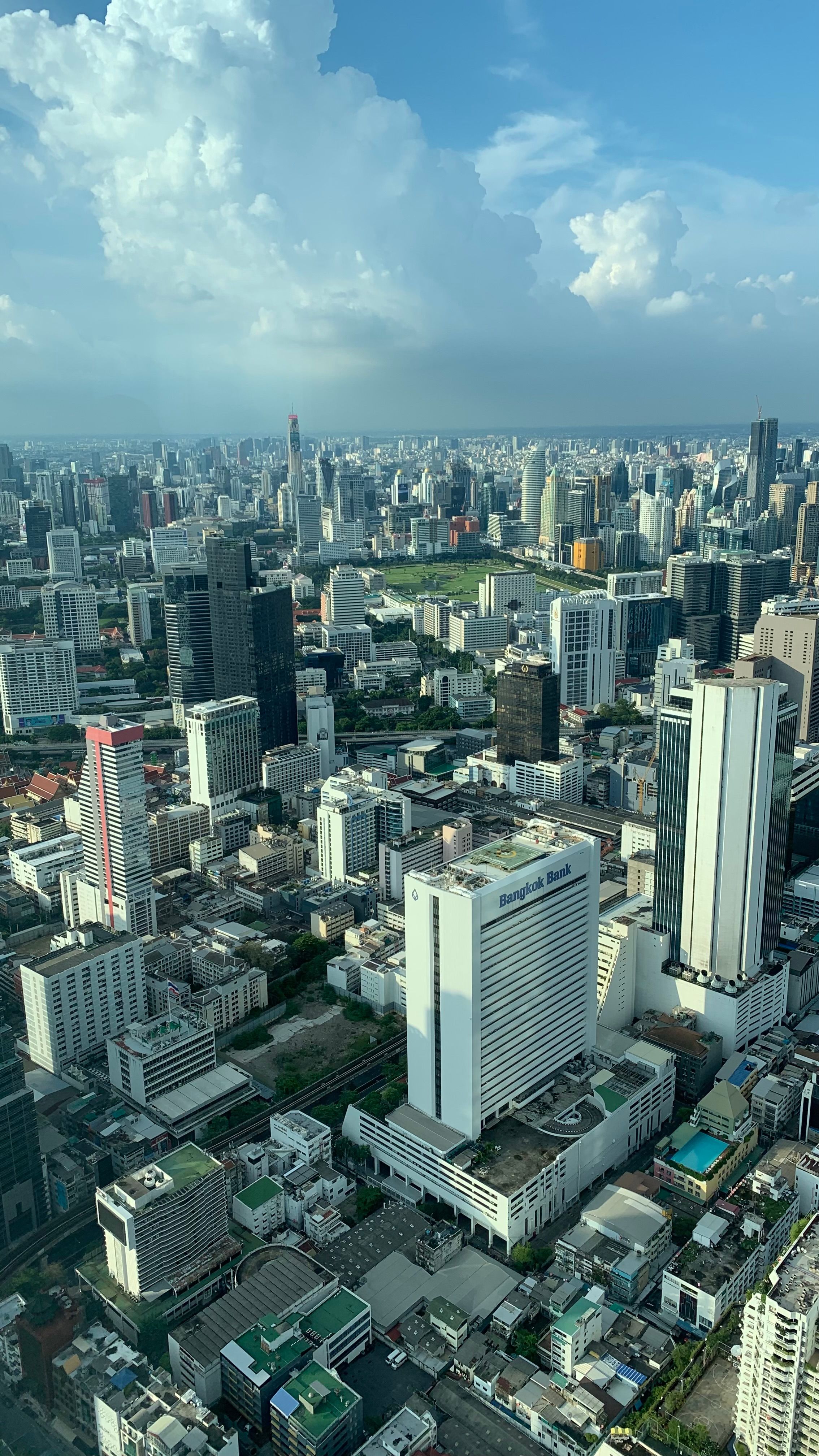 Stunning aerial view of Bangkok's modern skyline on a clear and sunny day.