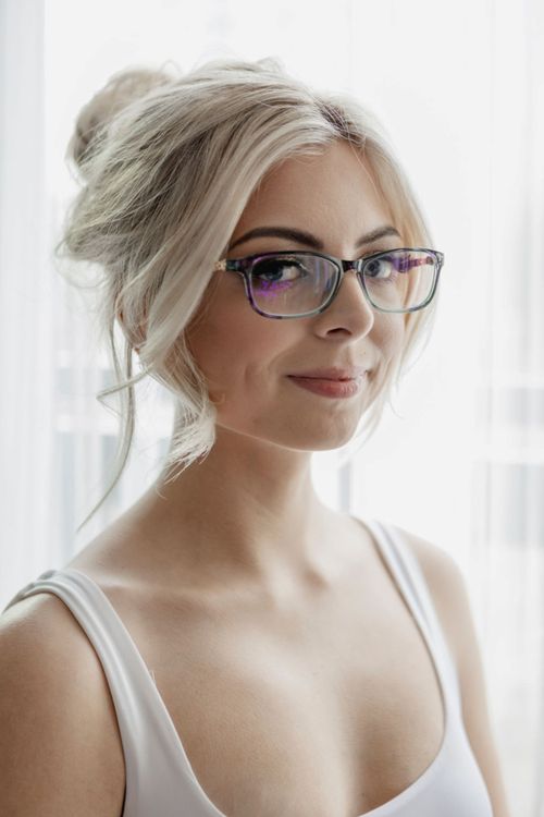 Free Elegant young woman posing indoors with fashionable glasses. Stock Photo
