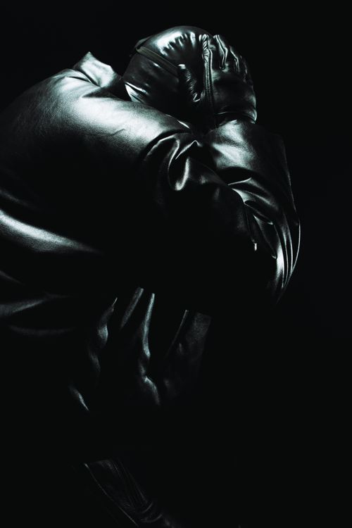 Free Stylized shot of a dark leather jacket against a black background. Stock Photo
