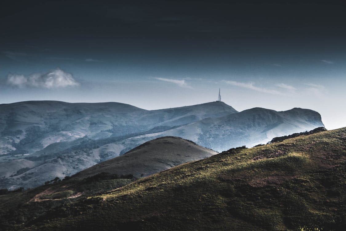 Green Grassy Hill during Foggy Day