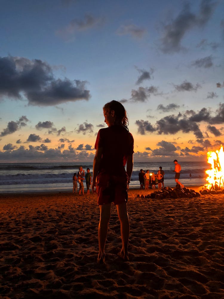 Silhouette Of Child Standing On Beach