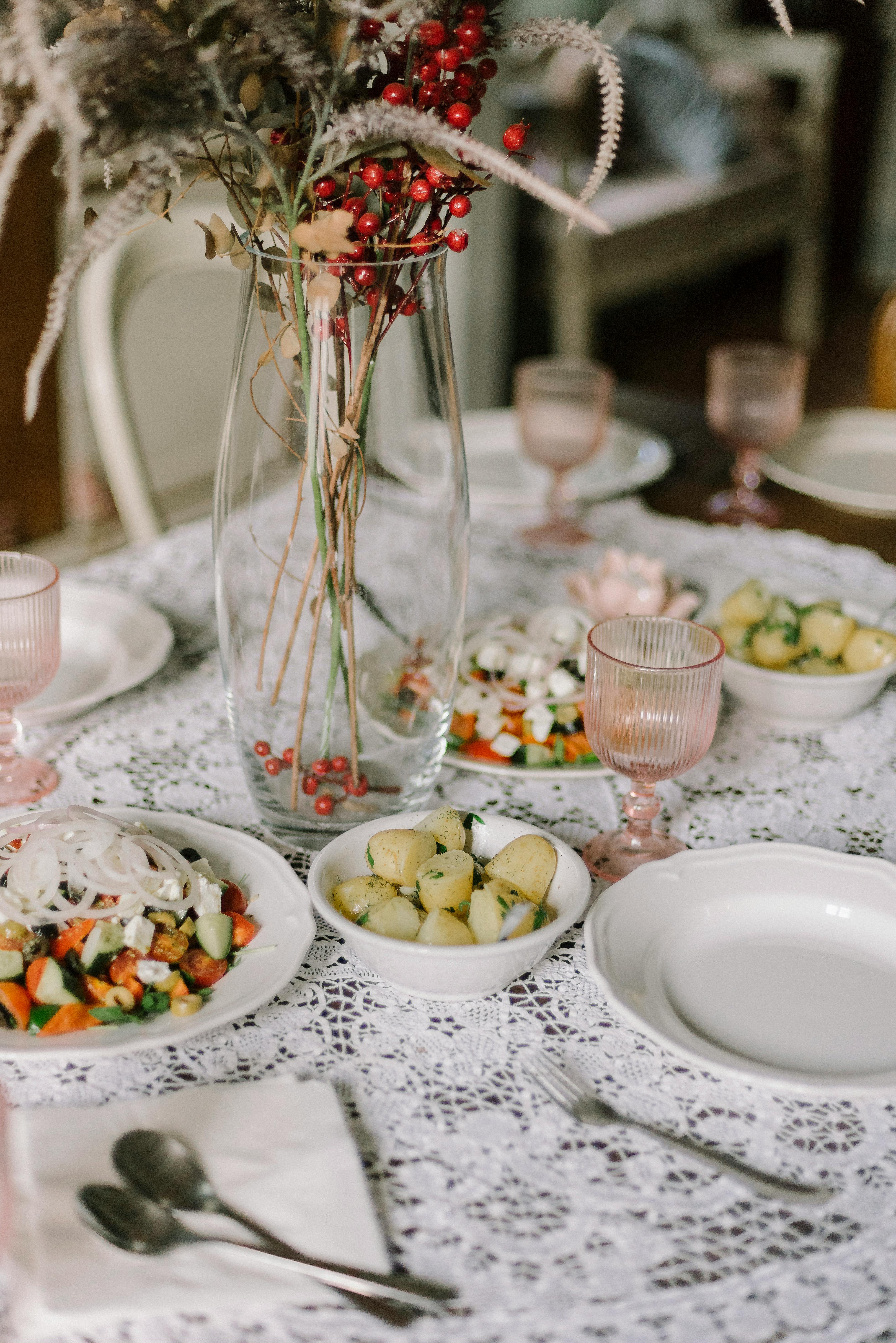 Beautifully set dining table with floral centerpiece and appealing dishes.