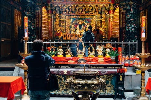 Tourists around Ornamented Altar in Buddhist Temple
