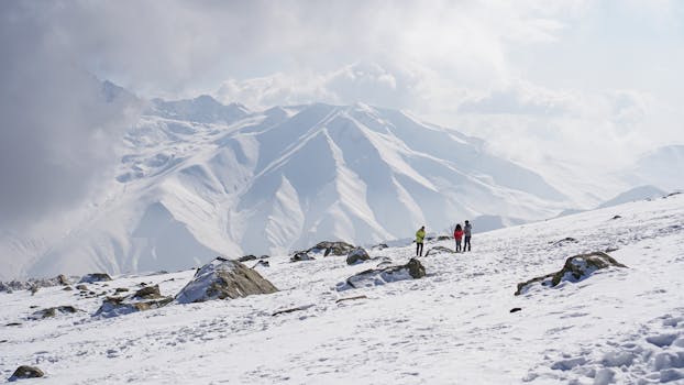 Hikers enjoy a breathtaking winter trek through snow-covered peaks in Kashmir, India.