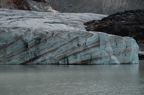 Free Beautiful glacier with textured ice surface reflected in tranquil water. Stock Photo