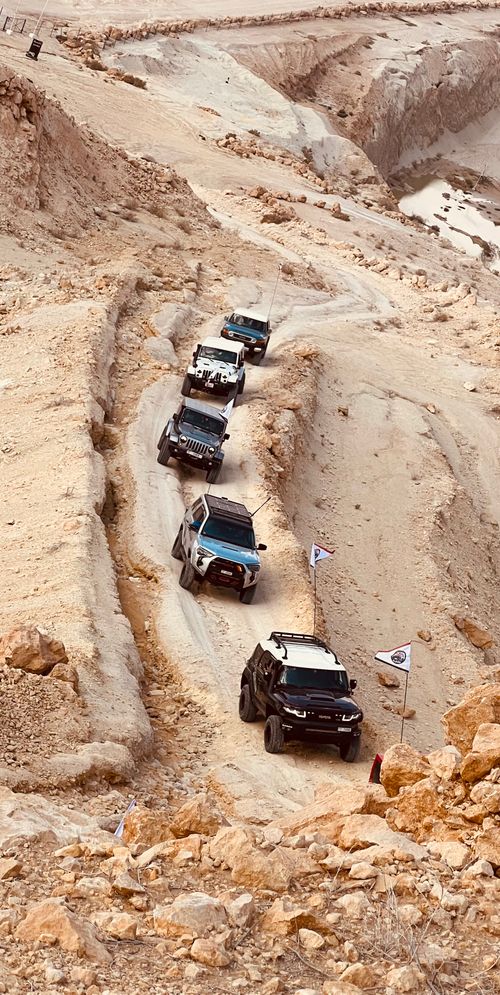 Free Explore thrilling off-road adventures in Sharjah's rugged desert terrain with a convoy of 4x4 vehicles. Stock Photo