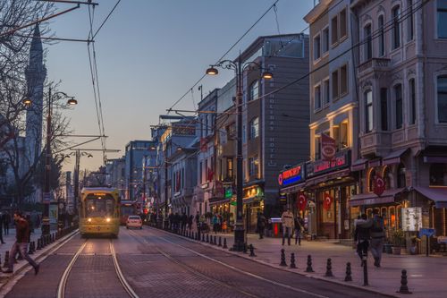 Free A lively Istanbul street with a tram and evening pedestrians. Stock Photo