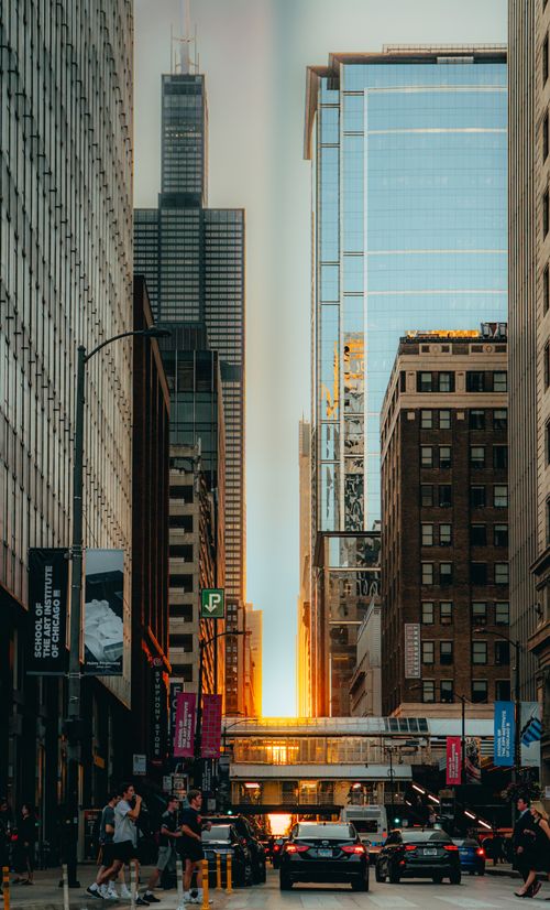 Free Dynamic street scene in Chicago capturing urban life with towering architecture at sunset. Stock Photo