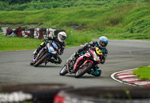 Free Exciting motorcycle race at Tarlac City track in the Philippines featuring two riders in action. Stock Photo