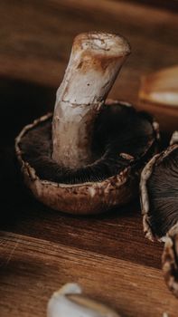 Detailed view of fresh Portobello mushrooms highlighting texture and earthy colors on a wooden surface.