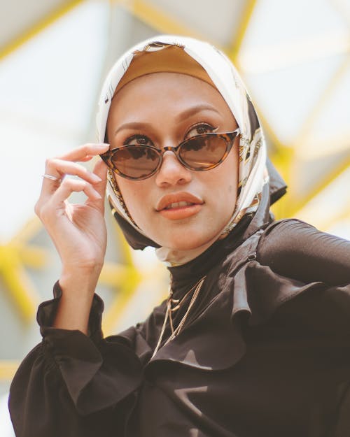 Photo Of Woman Holding Her Sunglasses