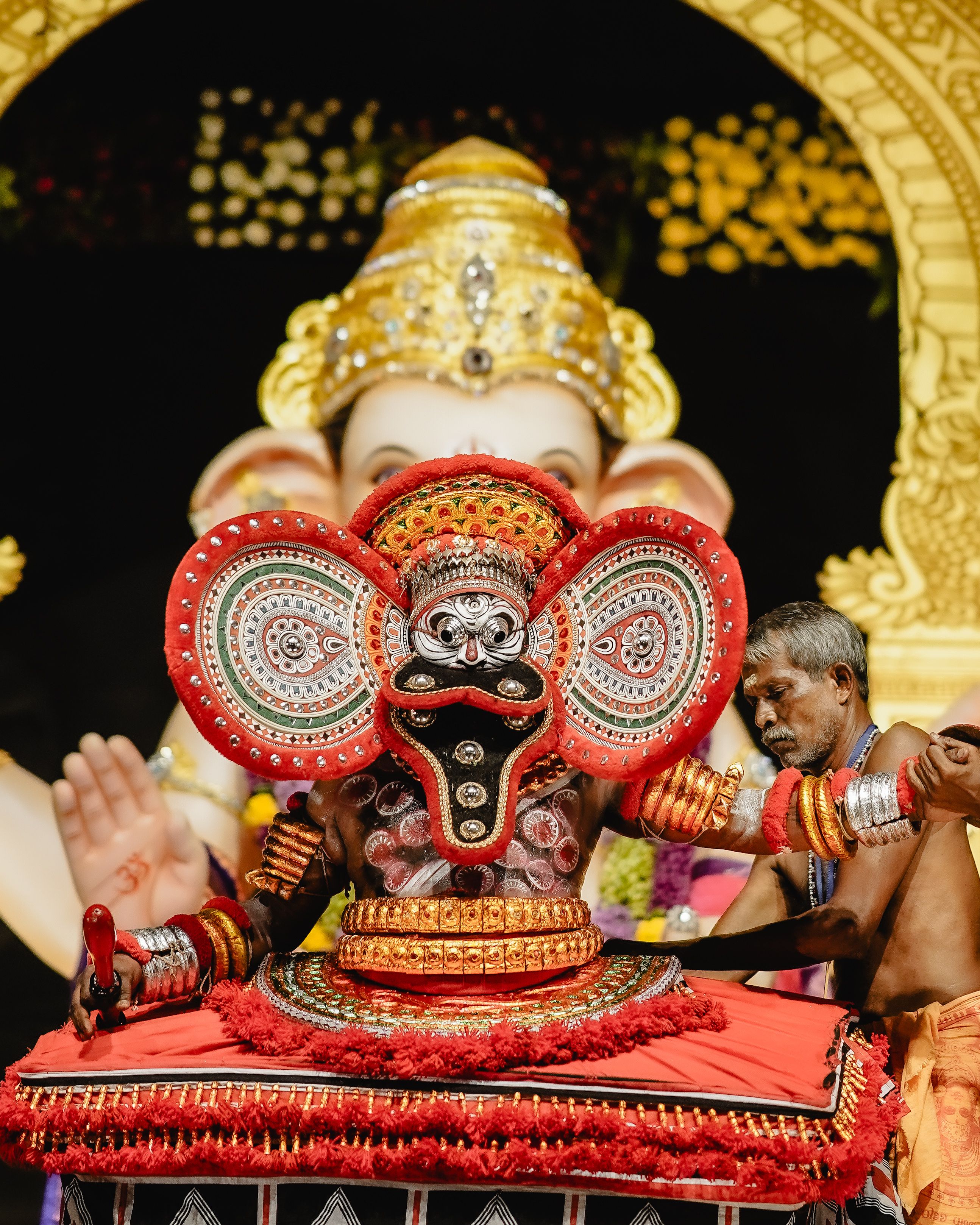 Dynamic Theyyam ritual performed in Nagpur with a Ganesh backdrop, capturing cultural vibrance.