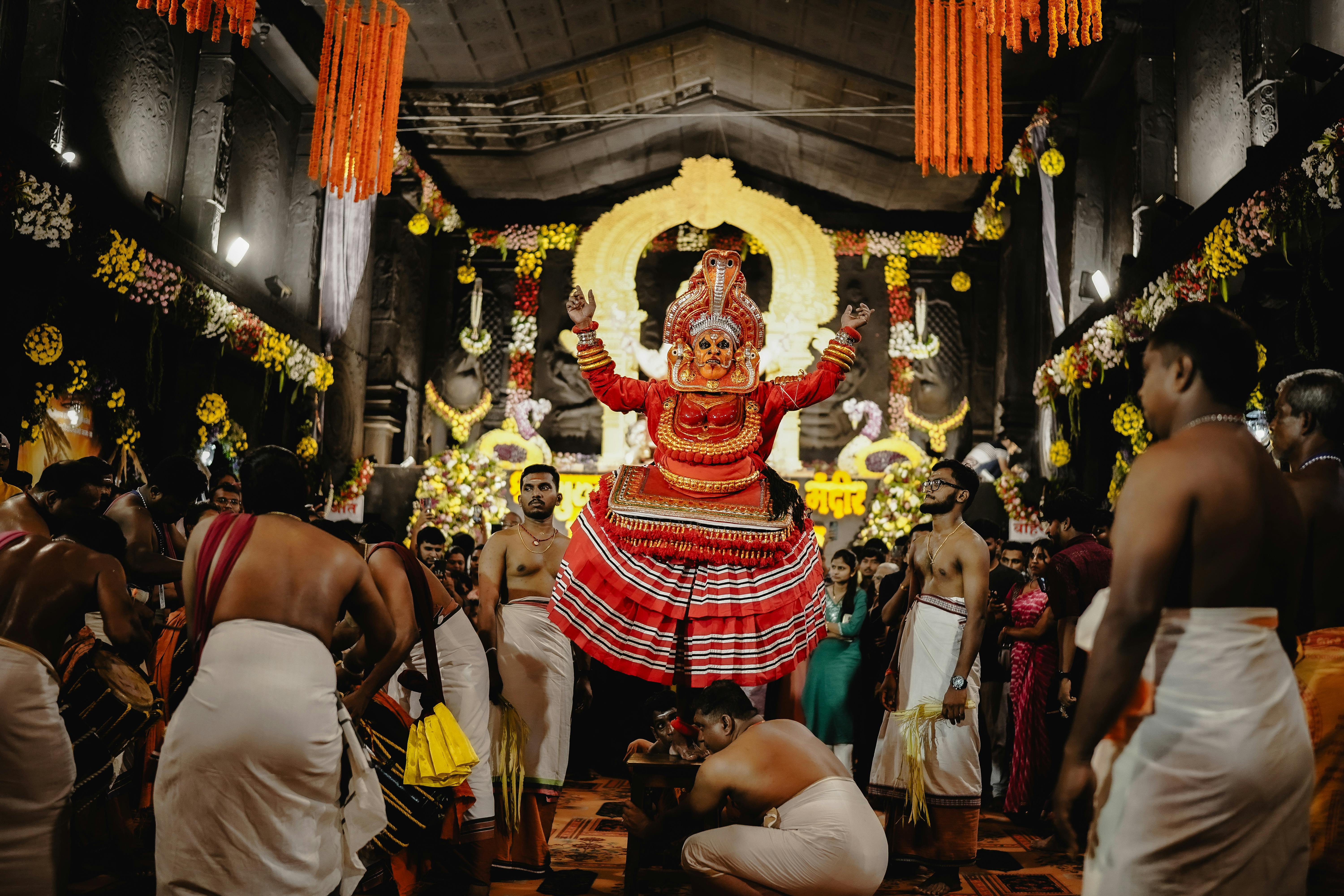 A vibrant Theyyam performance inside a decorated temple in Nagpur, Maharashtra, India.