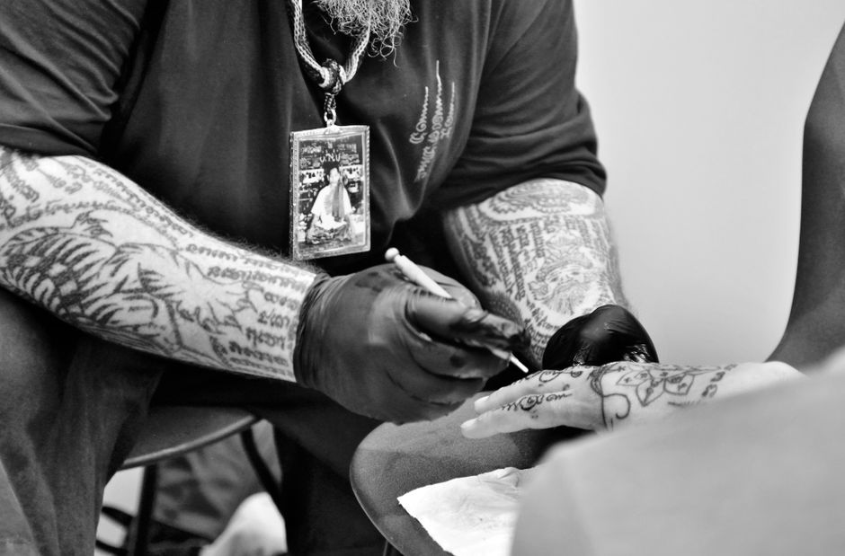 Tattoo apprentice practicing fundamentals under mentor guidance Tattoo apprentice practicing fundamentals under mentor guidance