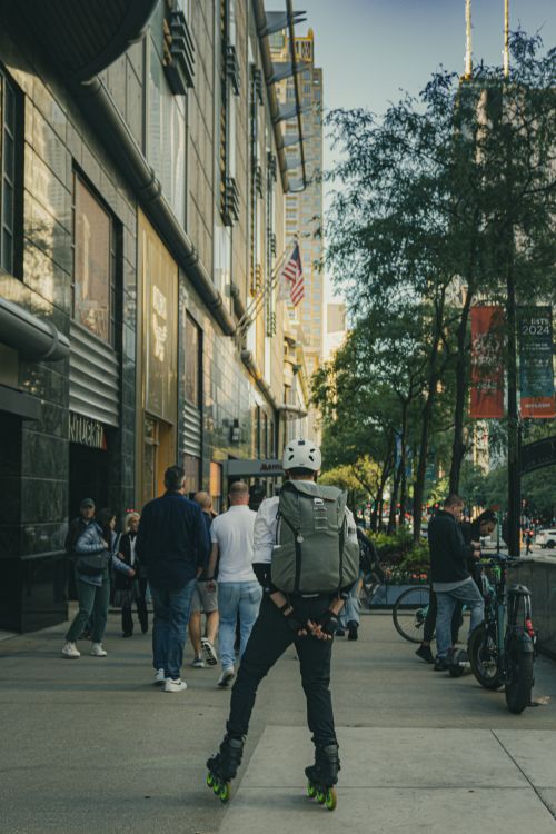 Free Skater navigating the lively streets of downtown Chicago, capturing urban culture. Stock Photo