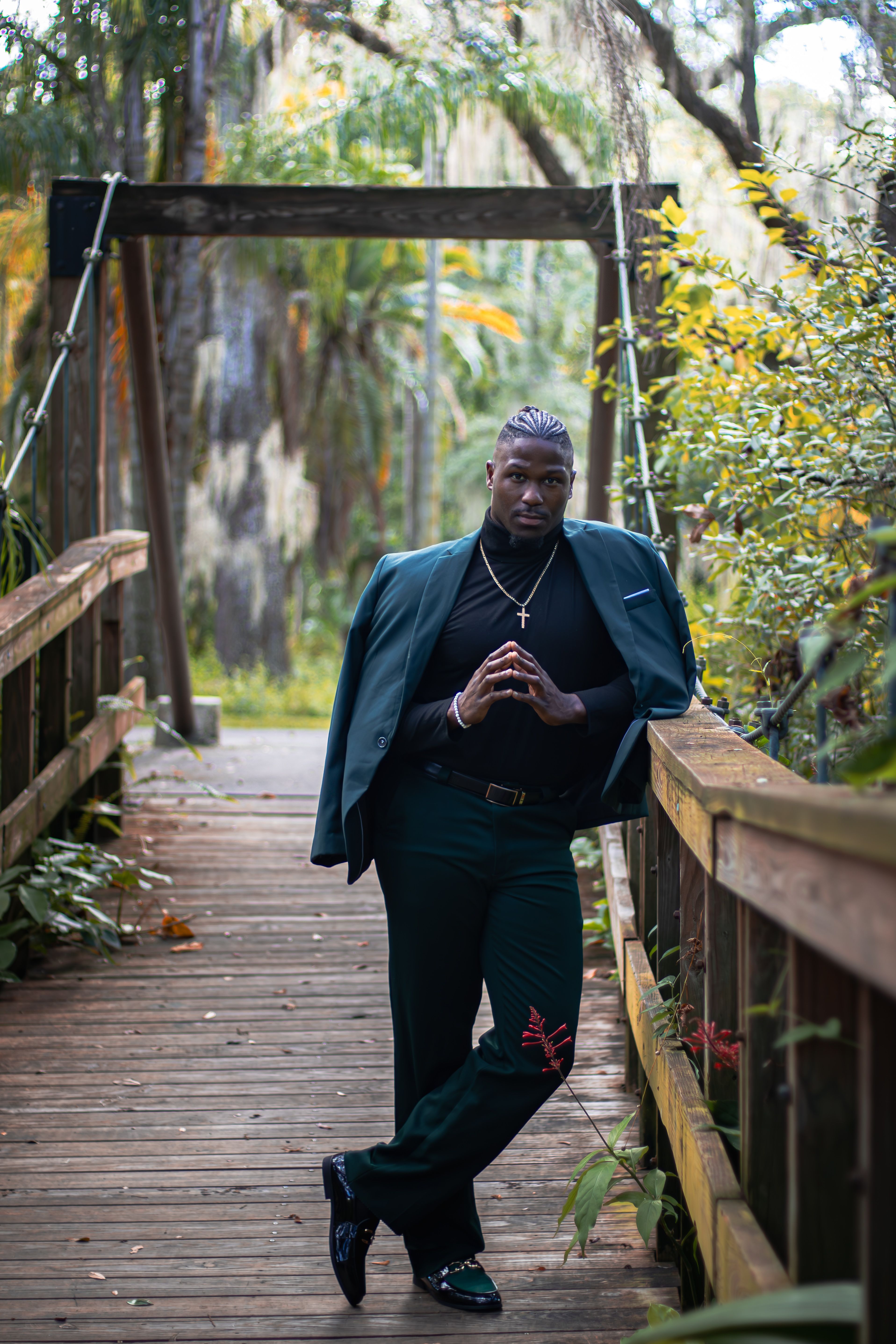 Stylish Man Posing on a Wooden Bridge in Nature · Free Stock Photo