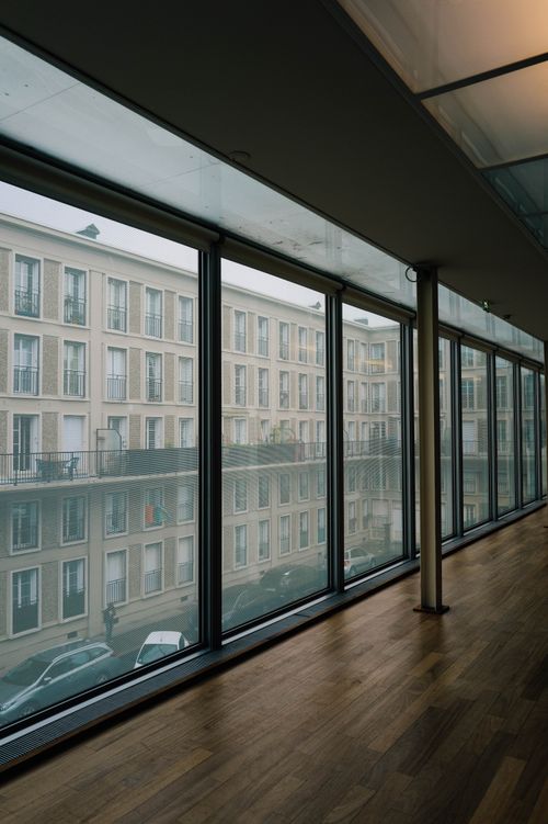 Free View of cityscape through large glass windows in a modern building interior. Stock Photo