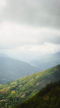 Lush green mountain landscape under a cloudy sky in Erbaa, Tokat, Turkey.