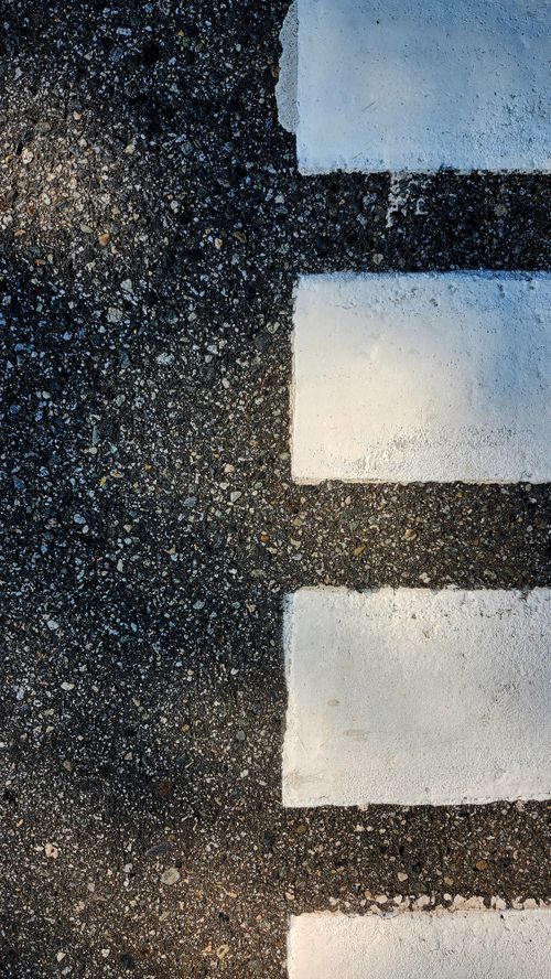 Free Detailed view of a crosswalk on an asphalt road in Vancouver, Canada Stock Photo