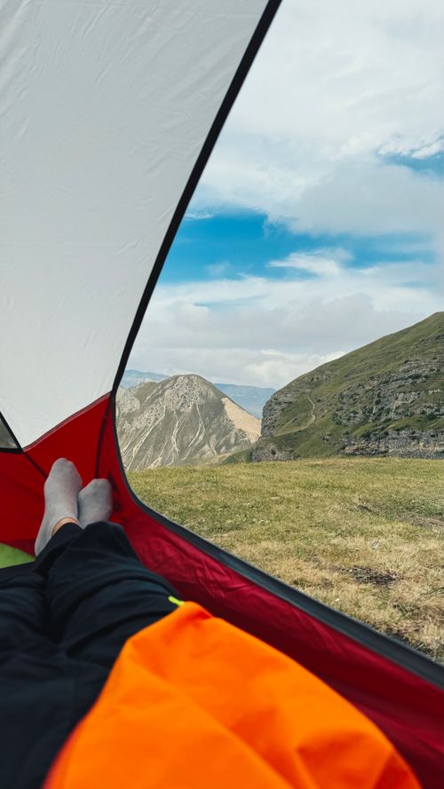 Free Idyllic mountain landscape seen from a cozy tent, perfect for hiking enthusiasts. Stock Photo