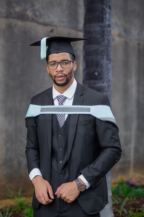 Young Graduate in Academic Attire Outdoors · Free Stock Photo