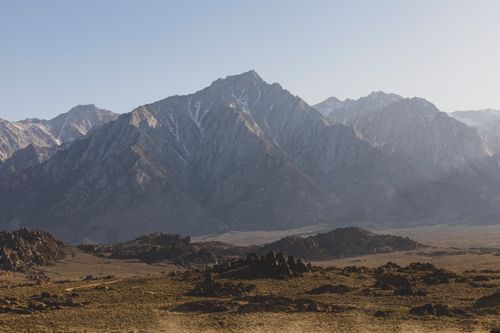 Free Breathtaking landscape of a rugged mountain range under clear skies and soft lighting. Stock Photo