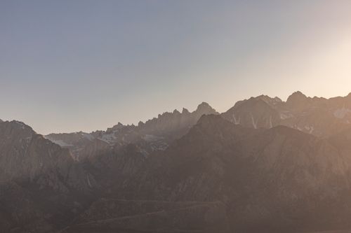 Free Scenic view of a mountain range at sunrise with soft light and shadows. Stock Photo