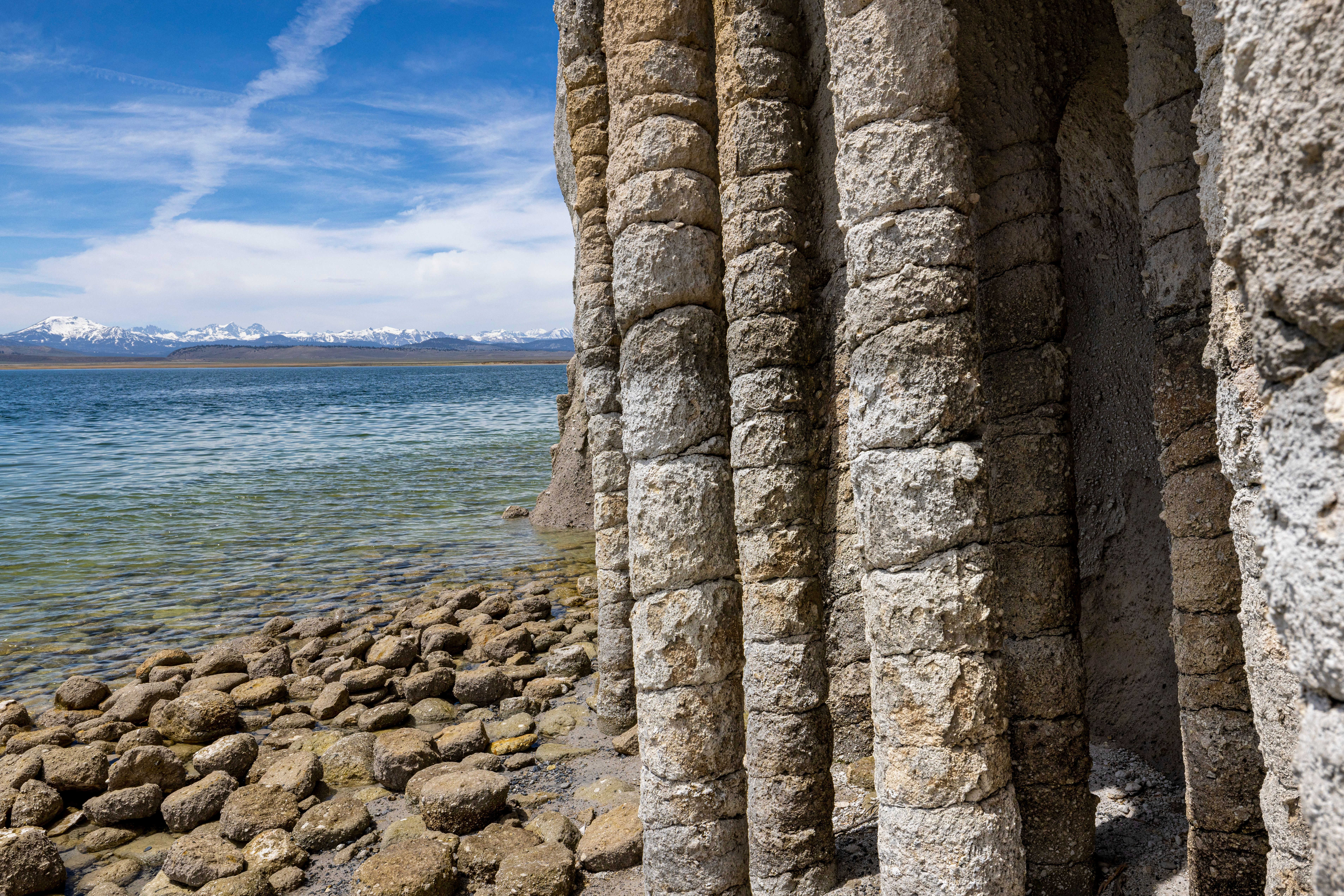 Ancient Stone Columns by Tranquil Lake Shore · Free Stock Photo